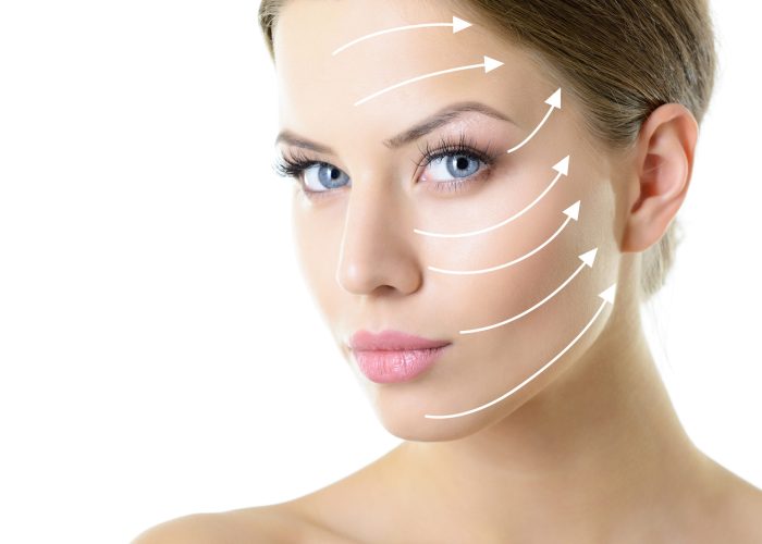 Grid of lines showing facial lifting effect on skin of beautiful young woman with healthy face and nice day makeup looking at camera, studio shot over white background